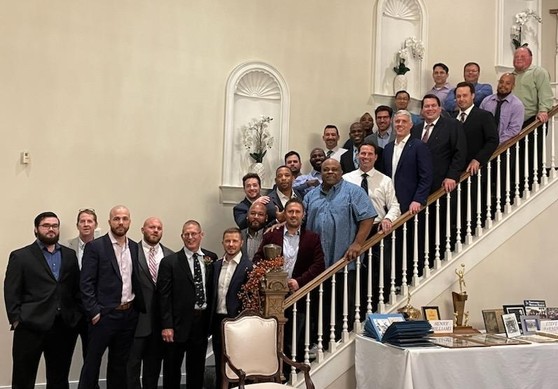 26 men pose on a staircase